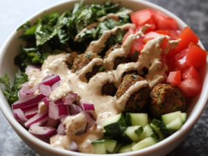 Try this falafel bowl with tahini sauce for a healthy, flavorful meal packed with plant-based protein and Mediterranean goodness. 
