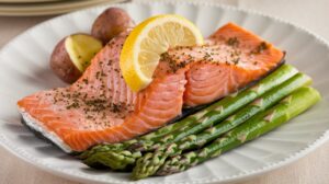 Baked salmon with lemon and herbs on a baking tray, ready to serve