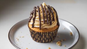 Boston Cream Pie Cupcakes topped with rich chocolate ganache and filled with smooth pastry cream, perfect for a sweet treat.

