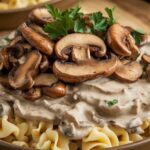 A plate of creamy mushrooms in a rich sauce, topped with fresh herbs and served with pasta, showcasing the ultimate creamy mushroom delight.