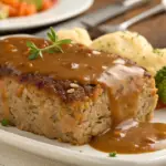 Cordon Bleu Meatloaf with Swiss Cheese and Ham served with rich gravy, perfect comfort food recipe.