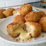 Crispy Fried Cheese Bites with golden brown coating and melted cheese inside. Perfect appetizer with dipping sauce.