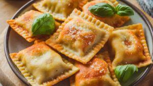 Crispy air fryer ravioli bites served with marinara sauce, ready for dipping. 