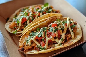 "Indian Fry Bread Tacos with ground beef, lettuce, tomatoes, and cheddar cheese on a crispy fry bread base."

