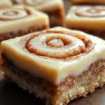 Cinnamon Roll Bliss Bars served on a plate with gooey cinnamon swirl and a light glaze on top.