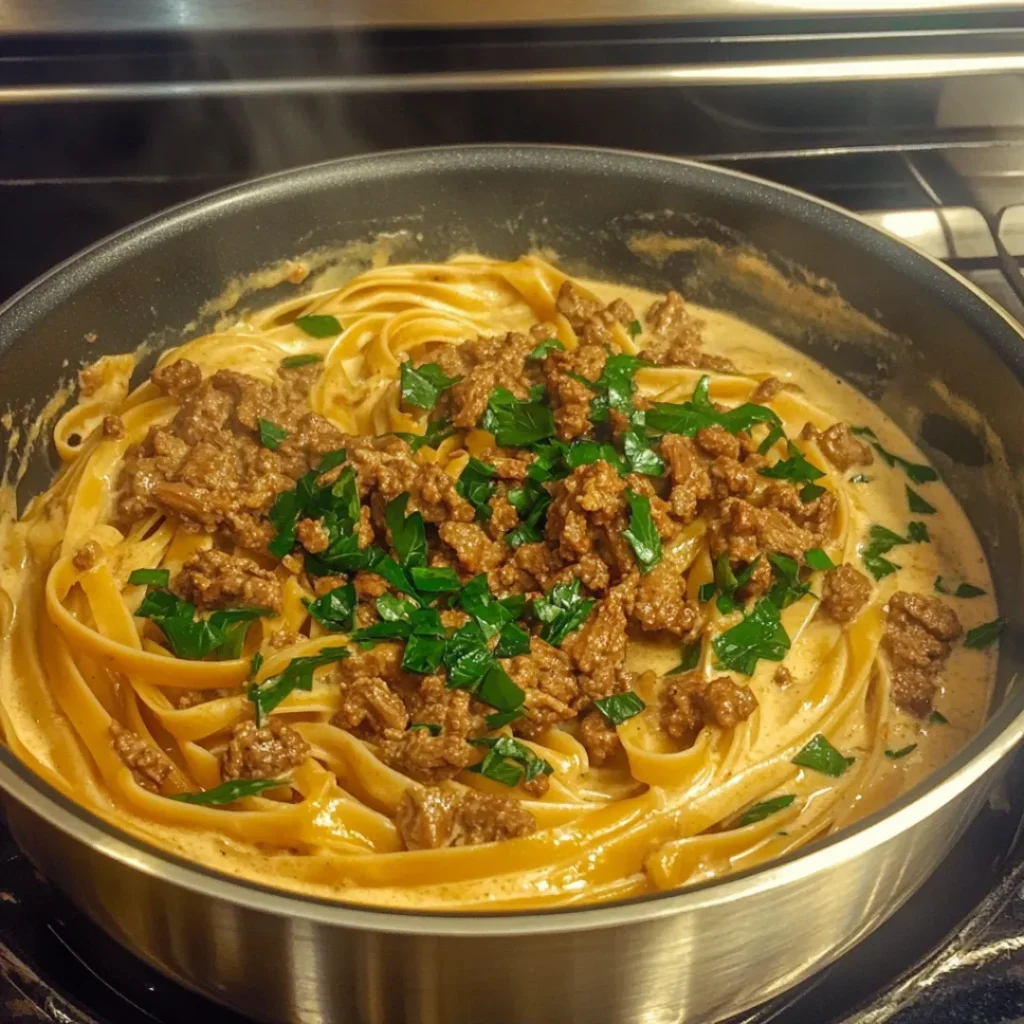 One-Pot Creamy Beef and Garlic Butter Pasta served in a bowl, garnished with parsley. Rich and creamy pasta with ground beef.