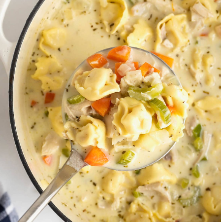 Creamy Chicken Tortellini Soup Creamy Chicken Tortellini Soup is the perfect blend of comfort, richness, and ease. With tender chicken, cheese-filled tortellini, vegetables, and a velvety cream broth, this soup delivers restaurant-quality flavor in a simple, home-cooked dish. It’s cozy enough for cold evenings yet light enough to enjoy year-round. This creamy chicken tortellini soup is especially popular because it feels indulgent without being complicated. Everything comes together in one pot, making it ideal for busy weeknights, family meals, or make-ahead lunches. Why You’ll Love Creamy Chicken Tortellini Soup This soup earns a permanent spot in your rotation because it’s: Rich and creamy without heavy techniques Hearty and filling thanks to tortellini and chicken Quick to prepare (ready in about 30 minutes) One-pot friendly with minimal cleanup Highly customizable with vegetables and seasonings It’s comfort food that feels both familiar and elevated. Ingredients You’ll Need Protein 2 cups cooked chicken (rotisserie, grilled, or poached) Salt and black pepper, to taste Pasta 1 package (18–20 oz) cheese tortellini (fresh or refrigerated) Vegetables 1 small onion, diced 2 carrots, sliced 2 celery stalks, chopped 3 cloves garlic, minced 2 cups fresh spinach (or kale) Liquids & Dairy 4 cups chicken broth (low sodium preferred) 1 cup heavy cream ½ cup whole milk (optional, for lighter texture) Seasonings 1 tsp Italian seasoning ½ tsp paprika ½ tsp black pepper Optional: red pepper flakes Step-by-Step: How to Make Creamy Chicken Tortellini Soup 1. Sauté the Aromatics Heat olive oil or butter in a large pot over medium heat Add onion, carrots, and celery Cook 5–7 minutes until softened Stir in garlic and cook 30 seconds until fragrant This step builds the flavor foundation of the soup. 2. Build the Broth Pour in chicken broth Add Italian seasoning, paprika, and pepper Bring to a gentle simmer Let the flavors meld for 5 minutes. 3. Cook the Tortellini Add tortellini directly to the pot Simmer according to package instructions (usually 3–5 minutes) Stir gently to prevent sticking Tortellini cook quickly—avoid overcooking. 4. Add Chicken and Cream Stir in cooked chicken Reduce heat to low Add heavy cream and milk (if using) Simmer gently—do not boil. 5. Finish with Greens Add spinach Cook 2–3 minutes until wilted Taste and adjust salt and seasoning Tips for the Best Creamy Chicken Tortellini Soup Use rotisserie chicken for maximum convenience Keep heat low after adding cream to prevent curdling Add tortellini near the end so they stay tender Use fresh tortellini for the best texture Variations to Try Garlic Parmesan Version Add grated Parmesan cheese at the end Tuscan-Style Soup Add sun-dried tomatoes and extra Italian herbs Lighter Version Use half-and-half instead of heavy cream Spicy Twist Add red pepper flakes or a dash of hot sauce What to Serve with Chicken Tortellini Soup This creamy chicken soup pairs beautifully with: Crusty bread or garlic knots Simple green salad with vinaigrette Grated Parmesan cheese for topping Storage, Freezing & Reheating Storage Refrigerate in airtight containers Keeps 3–4 days Reheating Reheat gently over low heat Add broth or milk if thickened Freezing Not recommended due to cream and pasta texture Best enjoyed fresh or refrigerated Common Mistakes & How to Fix Them Soup too thick? Add warm broth or milk Tortellini too soft? Added too early—reduce cook time next time Cream separated? Heat was too high Frequently Asked Questions Can I use frozen tortellini? Yes—add directly to the soup and cook a few extra minutes. Can I make this soup ahead of time? Yes, but it’s best within 1–2 days for optimal texture. Can I use uncooked chicken? Yes—simmer diced chicken in the broth before adding tortellini. Is creamy chicken tortellini soup filling? Absolutely. It’s a complete meal in one bowl. Printable Recipe Card (Quick Copy) Prep: 15 minutes Cook: 20 minutes Yield: 6 servings Sauté vegetables Simmer broth and seasoning Cook tortellini Add chicken and cream Finish with spinach Final Thoughts Creamy Chicken Tortellini Soup is the ultimate comfort-meets-convenience recipe. It’s rich, satisfying, and easy enough for any night of the week—yet special enough to serve guests. Once you try it, this cozy soup is guaranteed to become a favorite in your kitchen. 🥣
