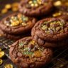 Ultra-realistic chocolate cookie with cracked surface and embedded gold-colored chocolate coins, glossy finish, studio lighting, neutral background