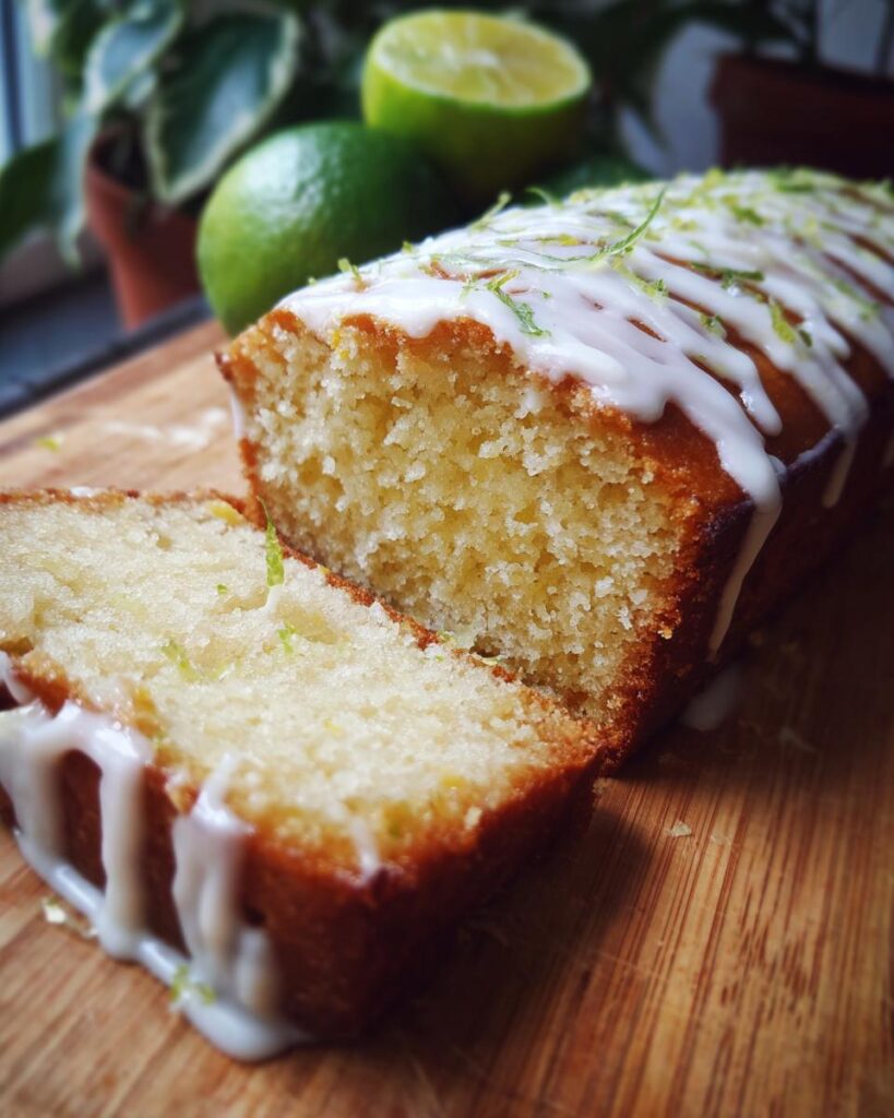 Ultra-realistic lime cake with golden crumb and visible zest, topped with glossy white chocolate drizzle, isolated on a neutral studio background with studio lighting