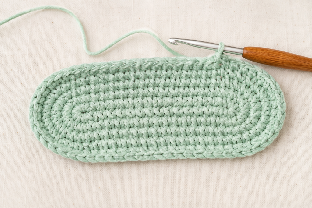 Crochet oval base made with single crochet stitches for a beginner handbag