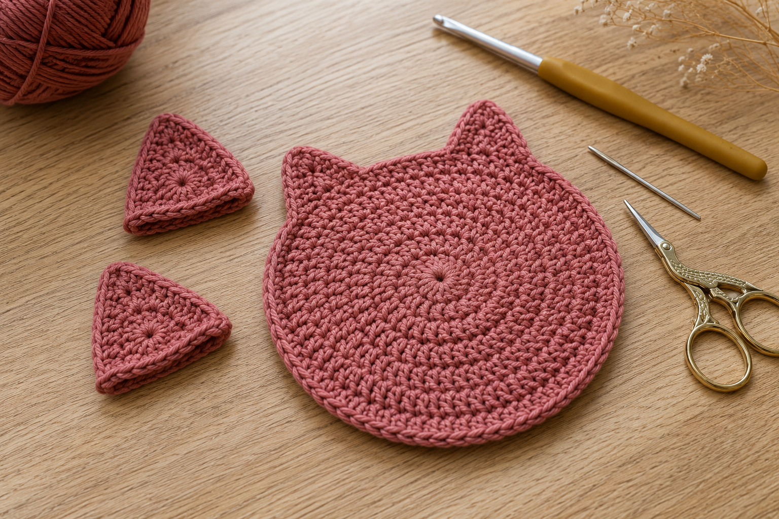 Two triangular crochet ears for a cat coaster